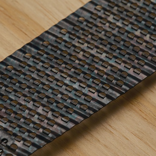 STANLEY 21-398 replacement surform blade with perforated holes, close-up angle on wood surface.
