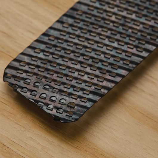STANLEY 21-398 replacement surform blade close-up on wood surface, showing metal file teeth pattern.