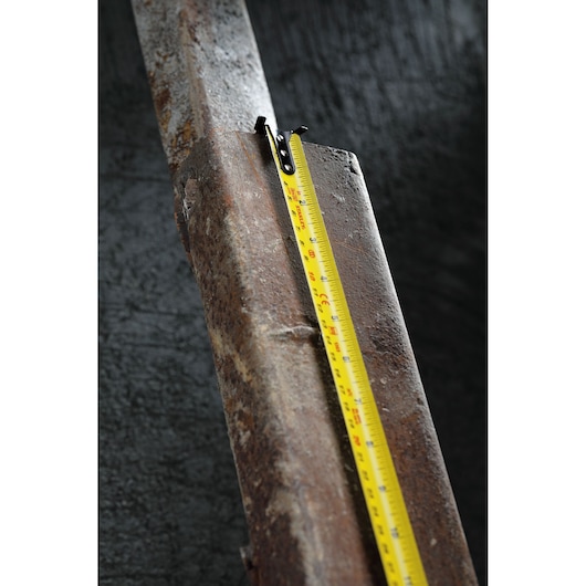 STANLEY 30-626 tape measure on a rusty metal surface, close-up photography.