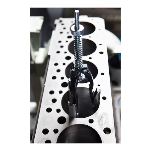 STANLEY 79-024 valve spring compressor tool in use, close-up view on engine block, silver and black metal.