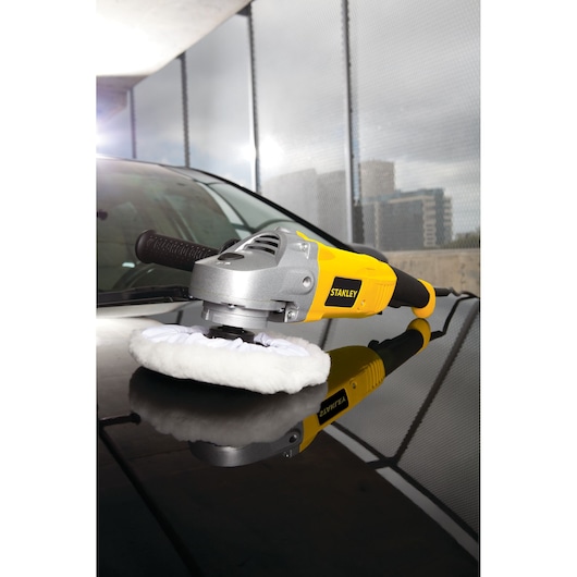 STANLEY STGP1318K polisher with yellow and black handle on car hood, side angle.