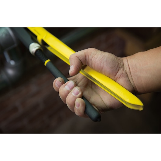 STANLEY STMT75926-8 hand tool close-up, yellow frame and black handle, being used for cutting.