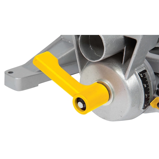 STANLEY STSM1525 miter saw close-up, showing yellow adjustment handle and angle gauge on metallic body.